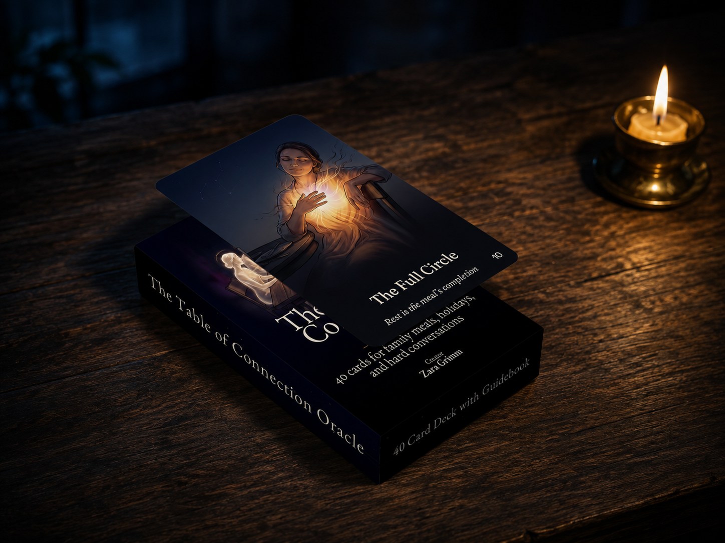 The Table of Connection box with The Full Circle card resting on it, on aged wood in candlelight